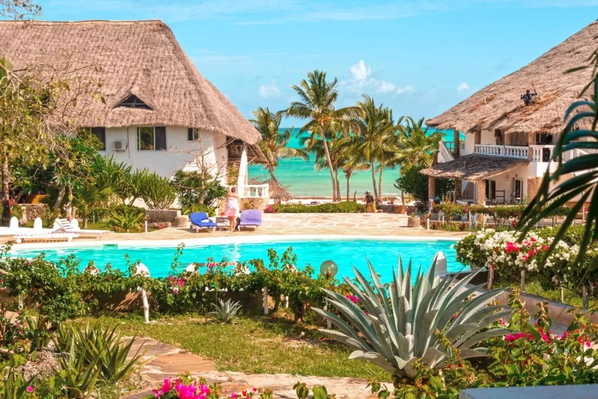 UN JACARANDA BEACH RESORT con capanne dal tetto di paglia vicino alla spiaggia.